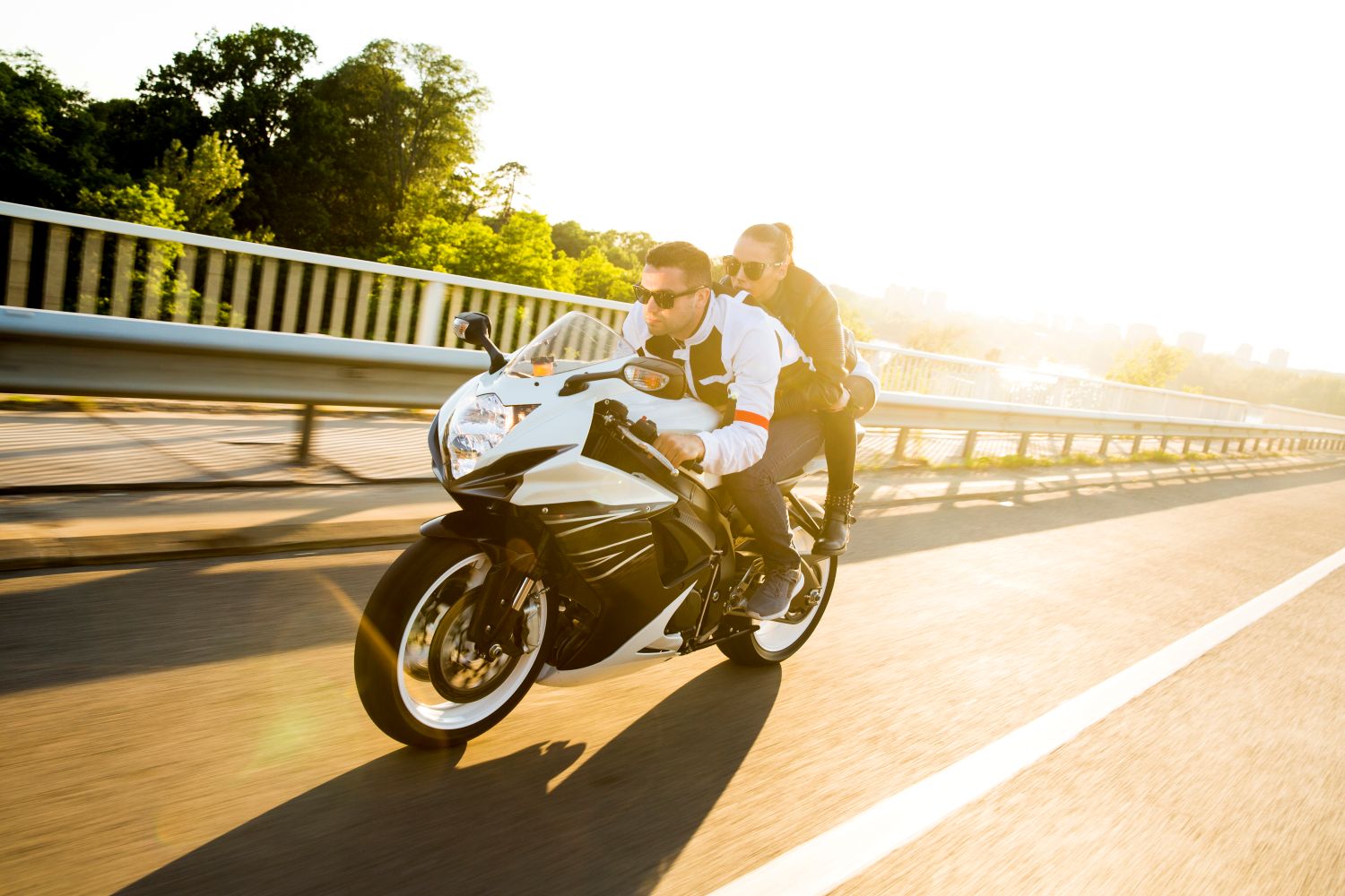 man and woman on motorcycle